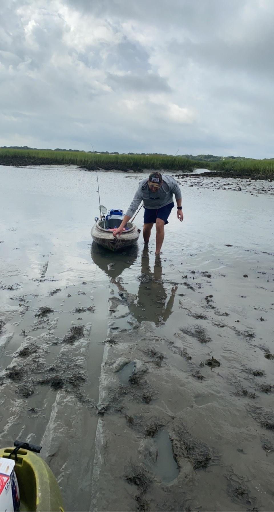 Man walking through the Marsh at low tide